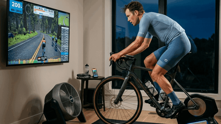 Cyclist on a smart indoor trainer during winter cycling training