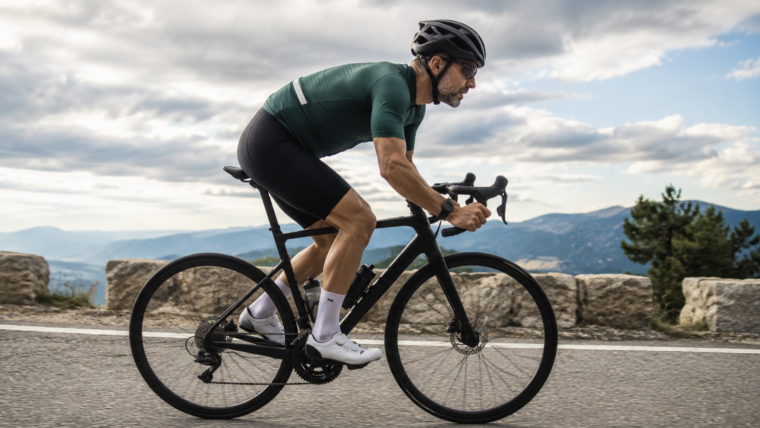 Masters cyclist riding hard on a road bike representing FTP benchmarks by age