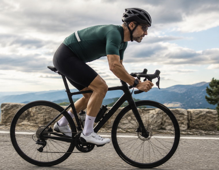 Masters cyclist riding hard on a road bike representing FTP benchmarks by age