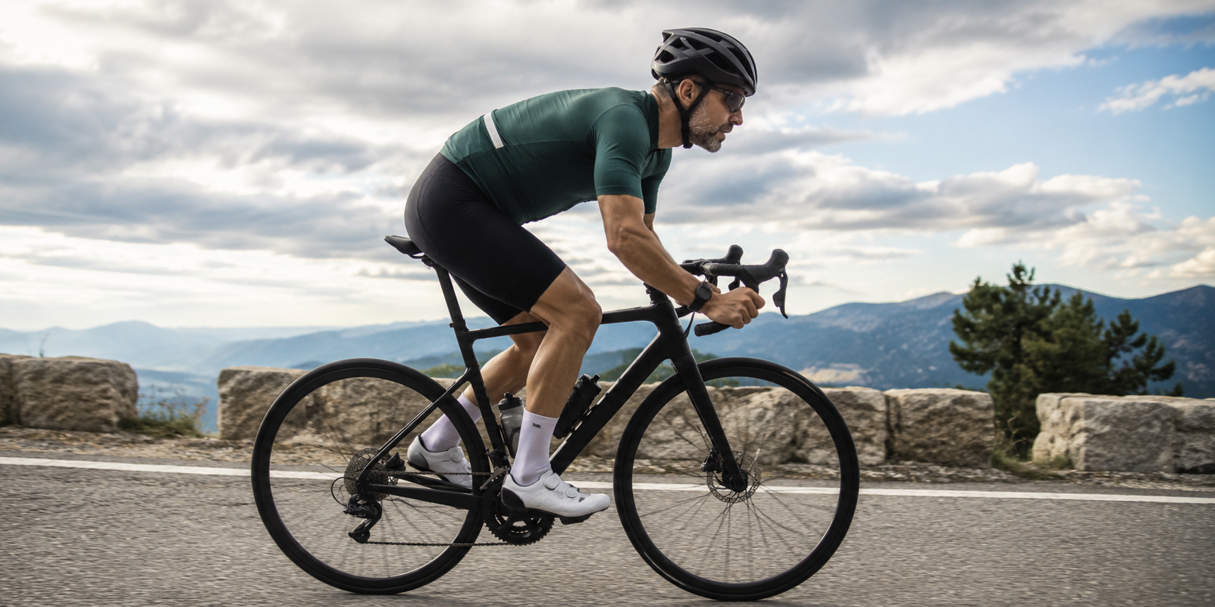 Masters cyclist riding hard on a road bike representing FTP benchmarks by age