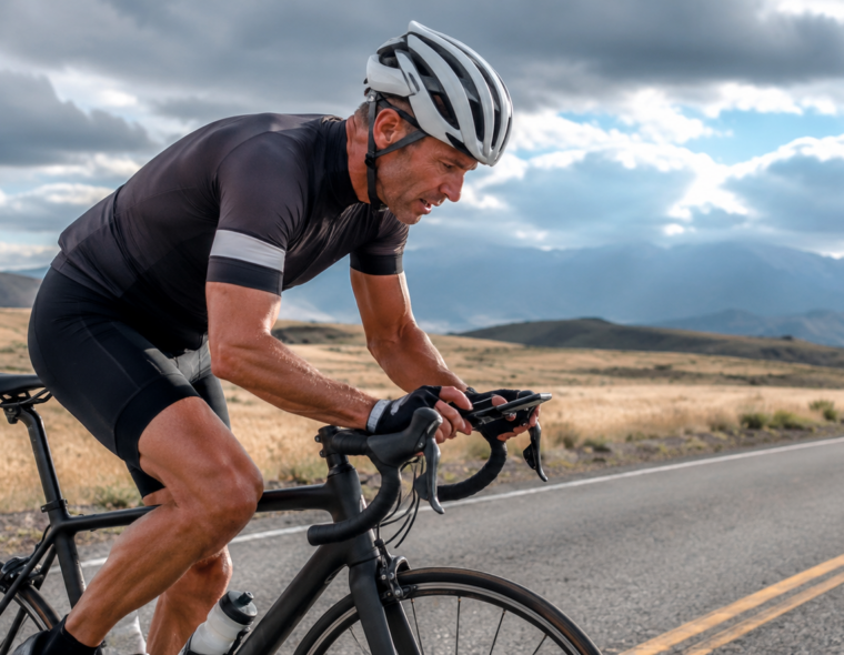 Masters cyclist riding hard on a road bike representing FTP benchmarks by age